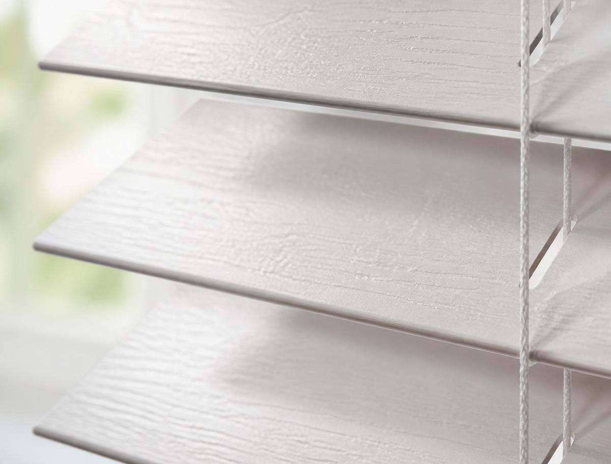 Espresso-finish faux wood blinds in a coastal California kitchen